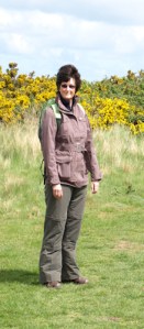 Ruth with bright gorse bushes on Norfolk coastal walk