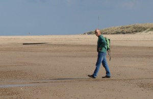 My husband walking to meet me on Sea Palling beach, Ruth's coastal walk