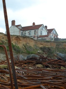 Abandoned house, on cliff at Happisburgh - coastal erosion on Ruth's coastal walk in Norfolk