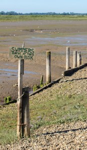 Swimmers bathe at their own risk, sign, Hamford Marshes, Essex