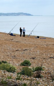 Fishermen near Dymchurch Redoubt, Ruths coast walk, Kent.
