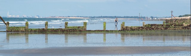 Cyclist on the beach, East Wittering, Ruth walking round the coast.