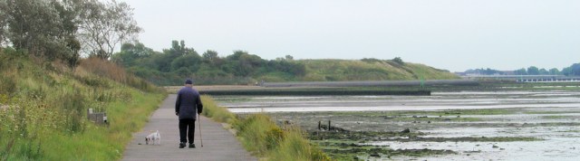 old man walking with dog, Solent Way, Ruth walks around the coast, Hampshire.