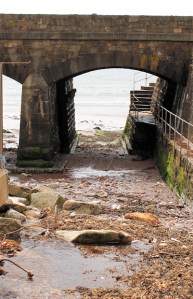 under railway bridge, Dawlish, Ruth on her coastal walk