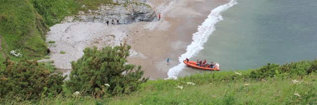 Looking down to Scabbacombe Beach, Ruth on her coastal walk.