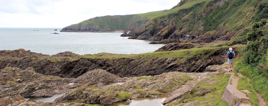 rounding Blackstone Point, Ruth walking the South West Coast Path