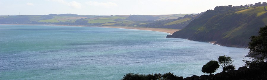 View ahead to Slapton Sands, Ruth walking around the coastline. Devon.