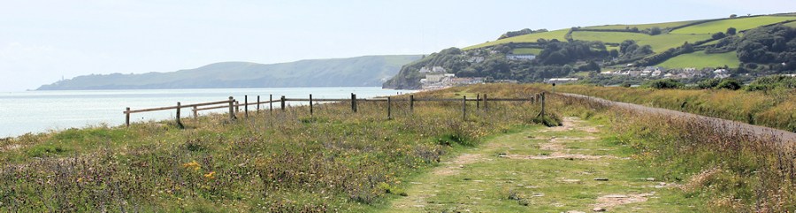 Torcross in distance, Ruth walking round the coast. DEVON