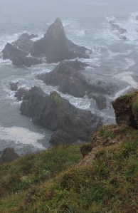 Rocks in the mist, Ruth on the South West Coast Path, Devon.