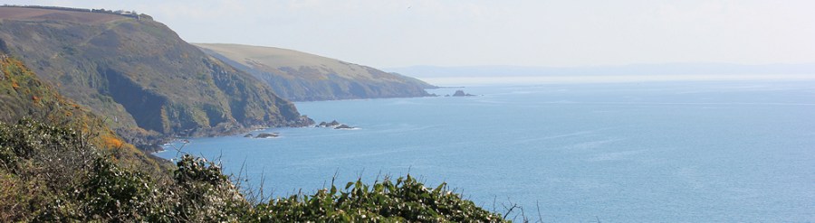 looking back across Whitsand Bay, Ruth walking round the coast, South West Coast Path
