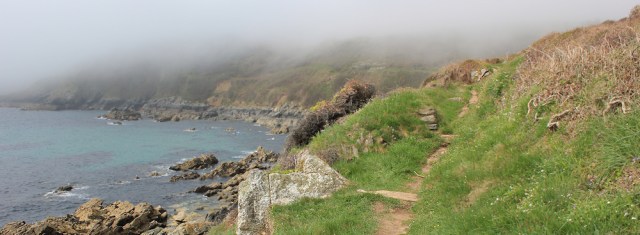 fog over Caragloose Point, Ruth walking on the SW Coast Path, Cornwall