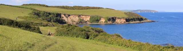 23 last look back to Rosemullion Head, Zone Point and Nare Head, Ruth walking the SW Coast Path