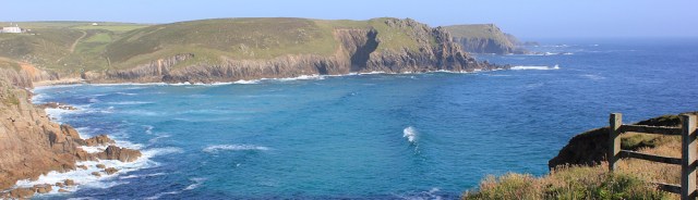 Looking back from Lands End, Ruth on her coastal walk