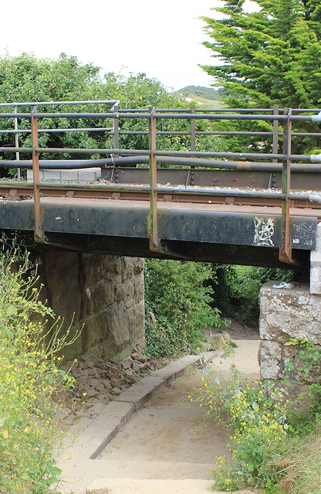 under railway bridge, Ruth on her coastal walk