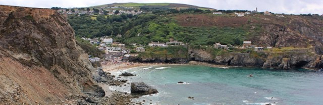 Looking back to St Agnes, Ruth walking the coast in Cornwall