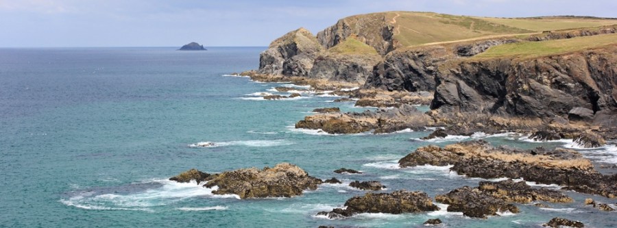 Looking to Gunver Head from Trevone, Ruth walking in Cornwall