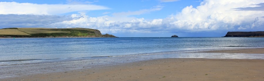 across Doom Bar to Stepper Point, Ruth walking the coast in Cornwall