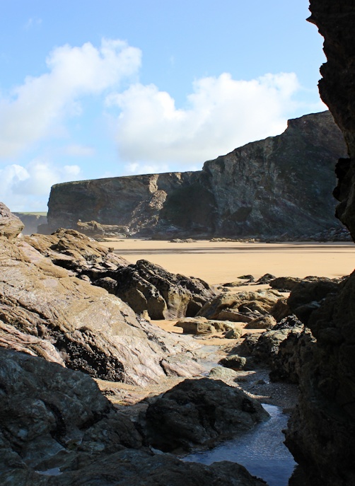 scrambling into Fruitful Cove, Newquay, Ruth walking the coast