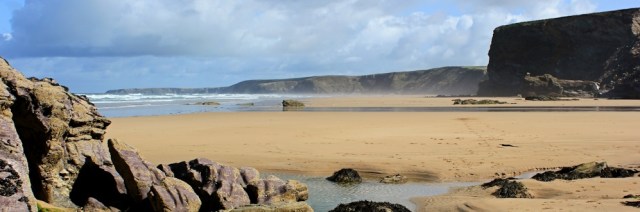 along Watergate Beach, Ruth walking the coast, Cornwall