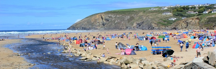 Beach at Mawgan Porth, Ruth walking the SWCP
