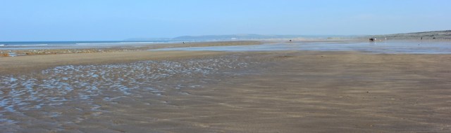 empty sands Westward Ho, Ruth on her coastal walk, North Devon