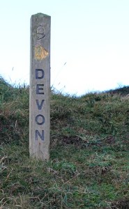 Devon signpost, Marsland Mouth, Ruth walking the coastal pat