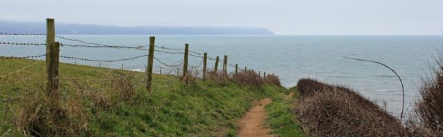 on Green Cliff looking back to Hartland Point, Ruth on coastal walk, SWCP, North Devon