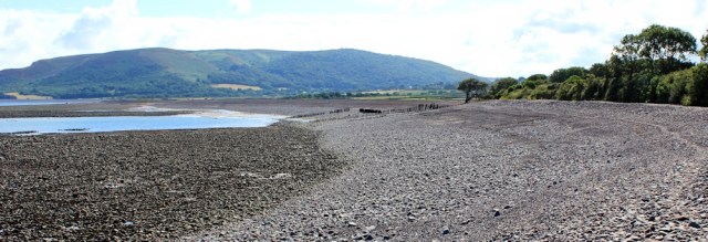 SWCP crossing shingle, Ruth on her coastal walk, Porlock
