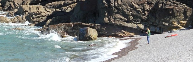 fisherman under Hurlstone Point, Ruth walking the coast