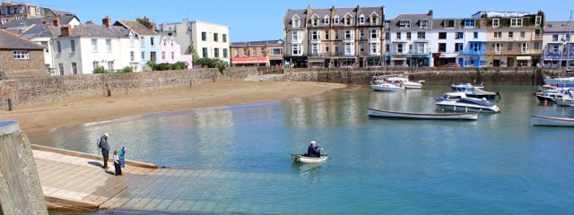 across Ilfracombe harbour, Ruth walking through Devon