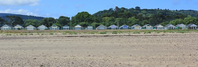 beach huts along Dunster Beach, Ruth walking the Somerset Coast Path