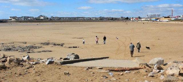 Ruth walking across Sandy Bay at Porthcawl