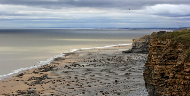 Ruth walking along the Wales Coast Path, from Nash Point