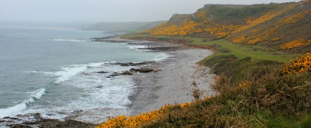 Port Eynon Bay, Ruth hiking the Wales Coast Path