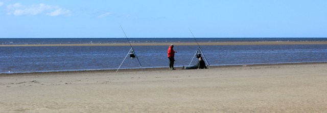 06 fishermen on beach, Ruth hiking through Llansteffan