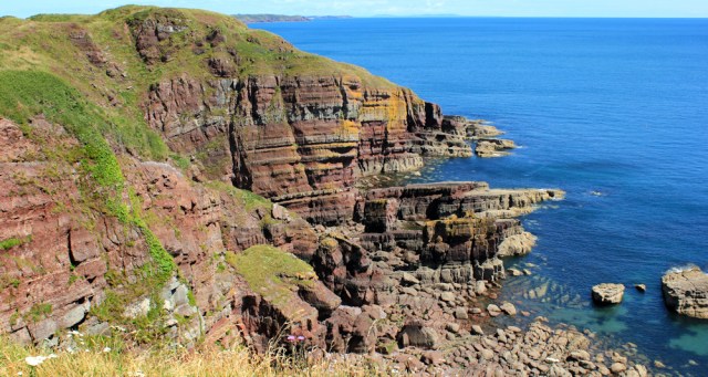 multicoloured cliffs, Ruth walking the coast in Wales, Stackpole