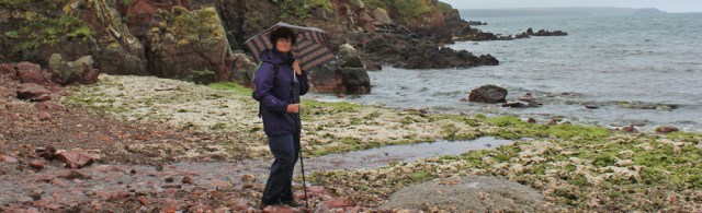 03 Ruth walking with an umbrella, Wales Coast Path