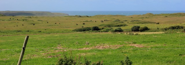  view over Castlemartin artillery range, Ruth walking in Pembrokeshire