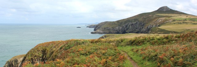  Carn Penberry looms, Ruth walking the Pembrokeshire Coast Path