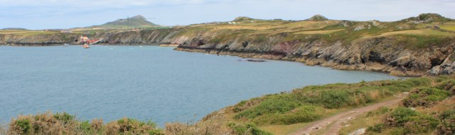 towards Ynys Dinas lifeboat and ferry station, Ruth hiking Pembrokeshire Coast