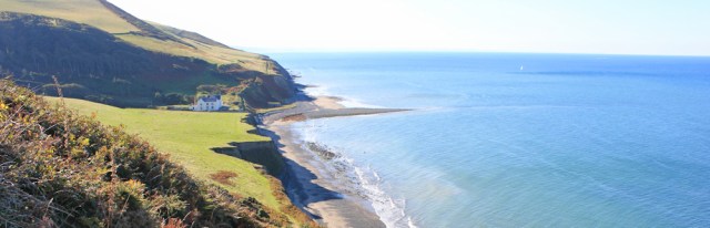 12 looking back to Wallog and Sarn Gynfelyn, Ruth Livingstone hiking the Wales coast