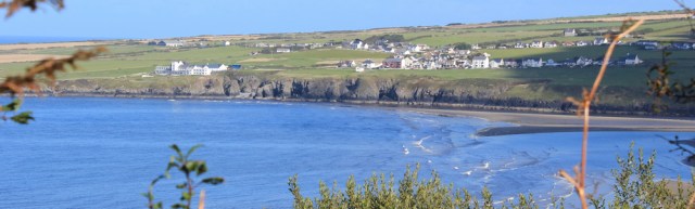 17 looking across to Gwbert, Ruth walking the Pembrokeshire Coast Path