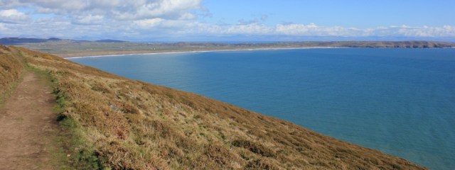 14 climbing hightowards Penarfynydd, Ruth on the Wales Coast Path