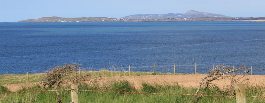 Holy Island in the distance, Ruth hiking in Anglesey,