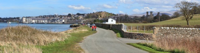 approaching Caernarfon, Ruth walking the Wales Coast Path