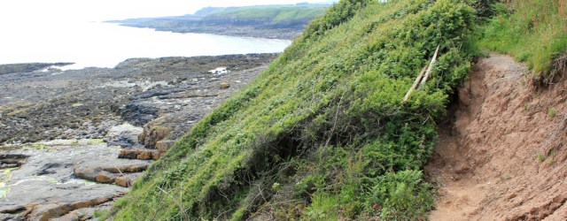 03 landslip on coastal path, Ruth walking through Moelfre, Anglesey