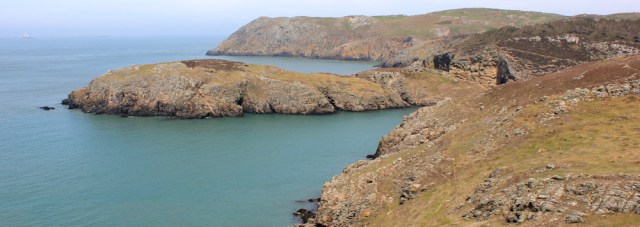 09 Ynys y Fydlyn with The Skerries beyond, Ruth hiking in north Anglesey