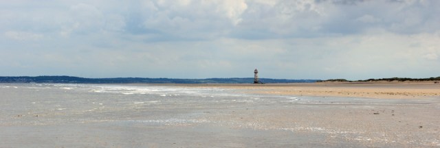 11 lighthouse, Point of Ayr, Ruth hiking the North Wales Coast
