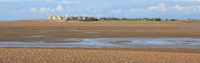 a07 view across to Hilbre Point, Ruth hiking the Wirral