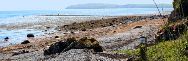 11 Walking across shingle, Ruth hiking the Mull of Galloway Trail, Scotland
